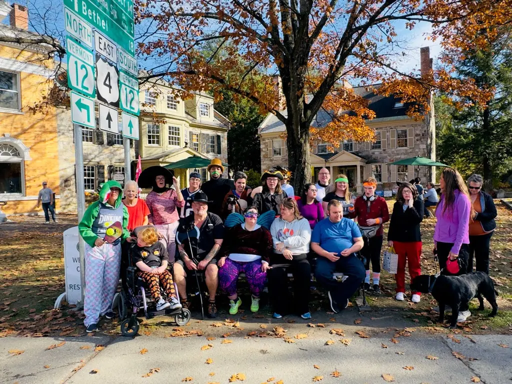 A large group of participants in costumes gathered in Woodstock village in the fall
